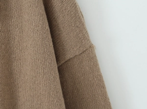 Detailed close-up of brown knit fabric showing fine stitching and soft texture