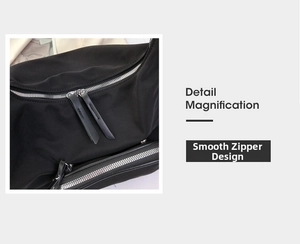 Detail magnification of smooth dual silver metal zippers on black nylon shoulder bag