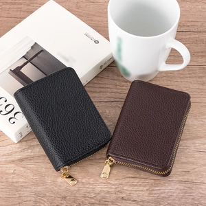 Litchi texture card holder wallets in black and dark brown on a wooden table