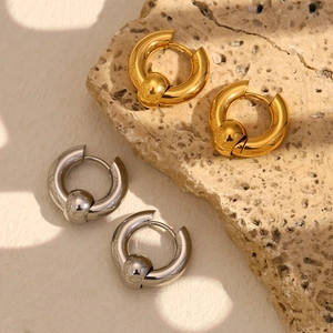 Minimalist 18K gold and silver plated stainless steel bead hoop earrings on natural stone