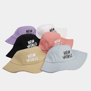 Detail of six colorful bucket hats with NEW WORLD embroidery in canvas cotton fabric