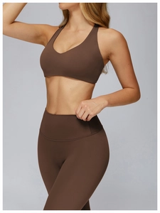 Detail of high-stretch dark brown racerback yoga bra and high-waist leggings set