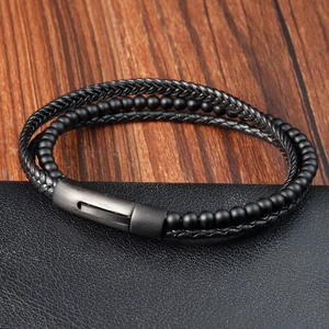 Close-up of men's multilayer braided leather bracelet with matte beads and magnetic clasp