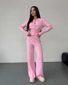 Detail view of pink knit cardigan with buttons and matching high waist wide leg pants texture