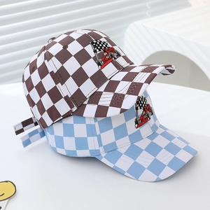 Detail of checkered racing embroidery and stitching on cotton kids baseball caps