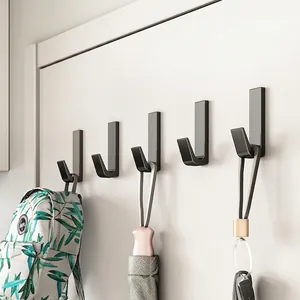 Minimalist matte black wall hooks set for hanging bags and umbrellas in entryway
