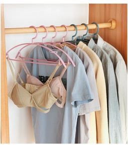 Detail of pink and blue anti-slip wide-shoulder hangers for t-shirts and delicates