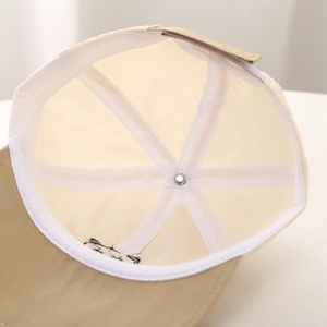 Detailed interior of baby panda cap showing six-panel stitching and reinforcing tape