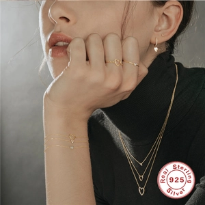 Elegant 925 sterling silver heart jewelry set with necklace and ring on a model