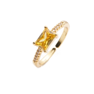 Princess cut yellow crystal gold ring with white zircon side stones on white background