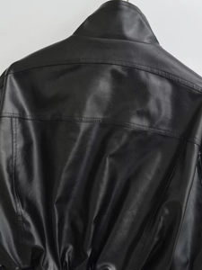 Close-up detail showing the stitching and texture on back of black faux leather bomber jacket