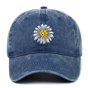Vintage washed blue denim baseball cap with embroidered daisy flower on plain background