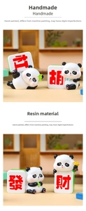 Macro detail of handmade resin panda figurine holding mahjong tiles with red characters