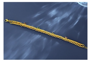 Detail of gold Cuban chain bracelet with colorful gemstones and water ripple lighting
