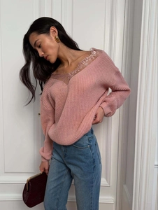 Close-up of delicate lace trim on the V-neckline of a mauve knit sweater top