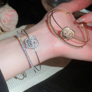Detailed macro of silver and gold zircon flower double-layered bangle with sparkling stones