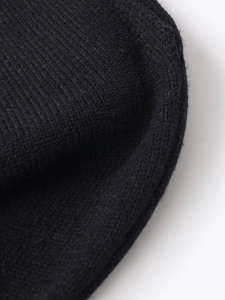 Close-up of high-quality black knit fabric with fine texture and elastic weave detail