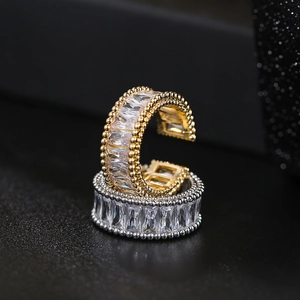 Detailed macro view of C-shaped open rings with pavé cubic zirconia and beaded edges