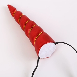 Detailed view of red unicorn horn accessory with gold braid and black elastic strap
