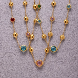 Chic stainless steel necklace with multifaceted colorful gemstones and golden beads