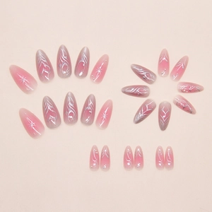 Close-up of almond press-on nails with silver star patterns and pearl embellishments