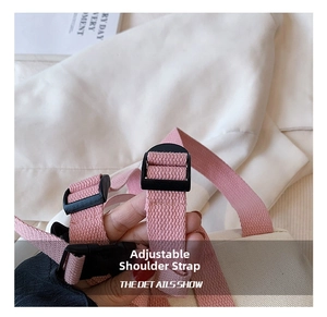 Close-up of adjustable pink canvas shoulder strap with black buckle for kids backpack