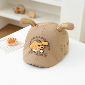 Detail of baby khaki beret with plush ears and yellow cartoon dog print design