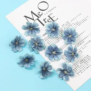 Macro detail of 10 gradient blue artificial plum blossom heads with fabric textures