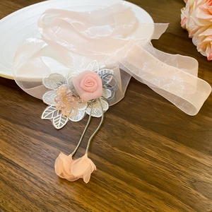 Detail of pink chiffon rose and delicate lace on floral ribbon choker necklace