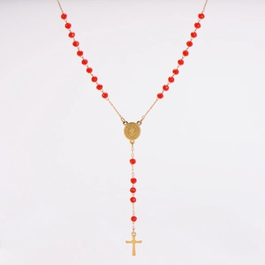 Detail of red crystal rosary necklace with gold medal and crucifix on white background
