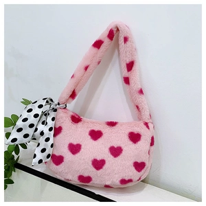 Detail of pink faux fur handbag with red heart patterns and a polka dot silk scarf handle