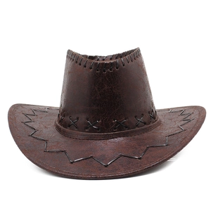 Detail of vintage brown western cowboy hat with black whipstitch edges and cracked leather texture