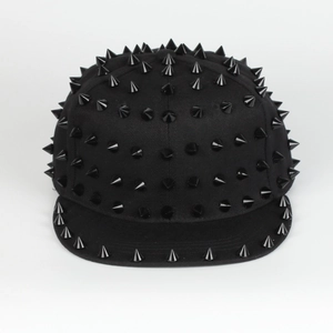 Detail of black snapback hat with metallic cone studs showing street style textures