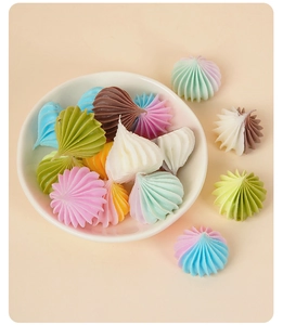 Detailed top view of colorful miniature dollhouse cream dollops in a white ceramic bowl