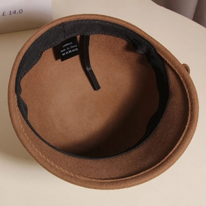 Close-up of brown wool equestrian hat interior with 100% wool label and sweatband