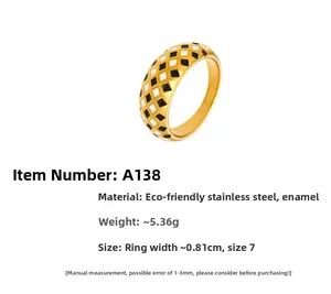 Detailed view of 18k gold plated ring featuring black and white enamel checkered pattern