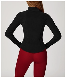 Detail view of women's black fleece jacket with slim-fit silhouette and princess seams