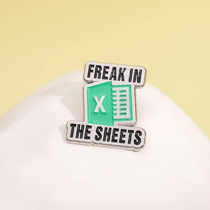 Excel sheet style enamel brooch with Freak In The Sheets text on white stone