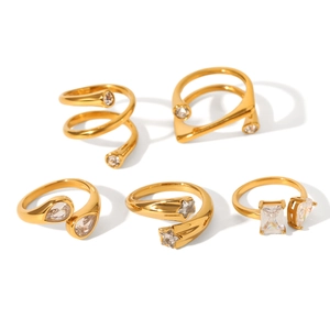 Minimalist gold plated irregular rings with clear crystals on a clean white background