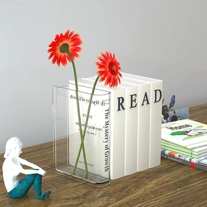 Transparent acrylic book vase with red flowers on a wooden desk for home decor