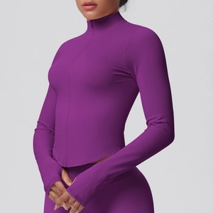 Detail of deep purple athletic jacket featuring thumbhole cuffs and ribbed fabric texture