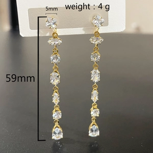 Detailed close-up showing 59mm length and 4g weight of gold teardrop tassel earrings