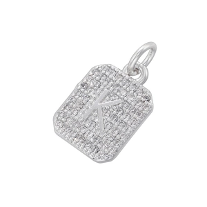 Macro view of silver square letter K pendant with cubic zirconia micro-pave setting