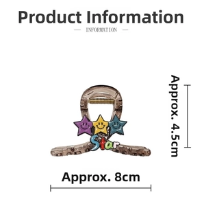 Detail view of brown claw clip with smiley star charms and Star text, sized 8x4.5cm