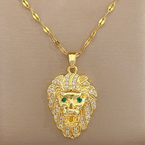 Detailed close-up of a gold lion head necklace with sparkling diamonds and green eyes