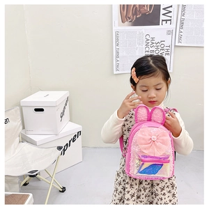 Detail of pink girls backpack with sequin rabbit ears and holographic front pocket pouch