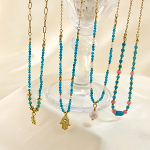 Detailansicht der Boho-Perlenketten mit blauen Natursteinen und goldenen Anhängern