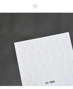 Detail of white embossed flower nail stickers JO-1864 with 3D floral texture and adhesive