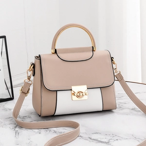 Elegant beige and white patchwork handbag with golden arc handle and crossbody strap