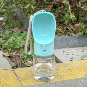 Portable pet water bottle in cyan green with wide drinking bowl and wrist strap detail
